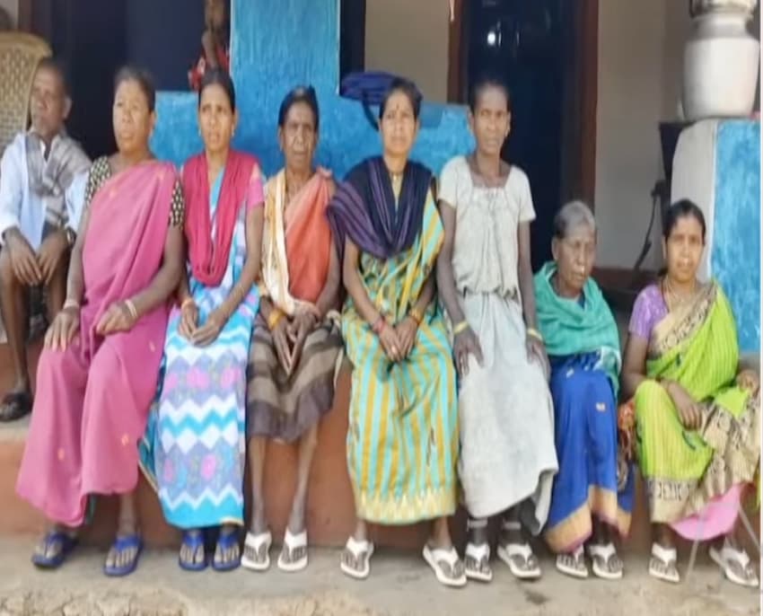 Pawan Kalyan presenting slippers to a tribal woman